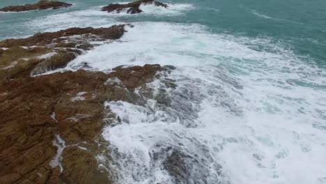 Waves-Over-Rocks-Aerial-Footage
