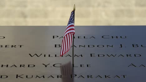 Close-Up-of-USA-Flag-Flying-in-911-Memorial-Plaque
