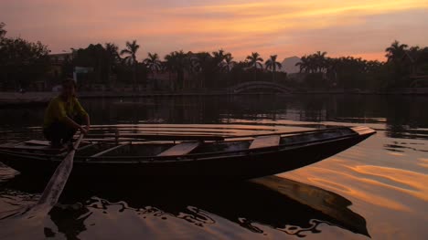 Lady-on-a-Traditional-Vietnamese-Boat-at-Sunset