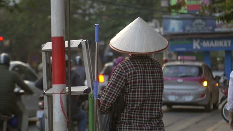 Vietnamese-Lady-Wearing-a-Conical-Hat-stood-on-a-Busy-Street