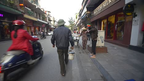 Man-Walking-with-Bucket-down-Vietnamese-Street