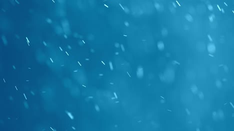 White-Swirling-Particles-on-a-Blue-Background