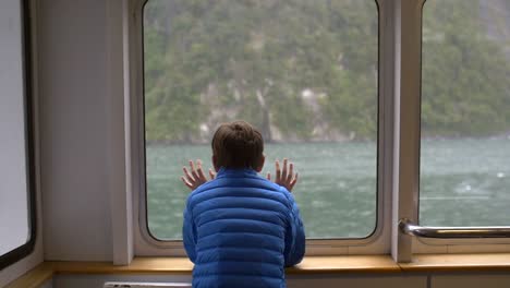 Young-Boy-Looking-Out-of-a-Ship-Window-2