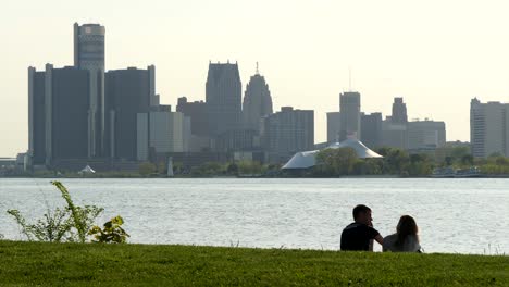 Young-Couple-Sat-in-front-of-Detroit-Cityscape