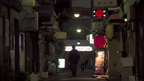People-Walking-Down-Dark-Tokyo-Alleyway