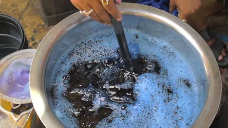 Man-Dyeing-Clothes-Blue-in-Street