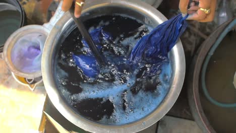 Man-Hand-Dyeing-Clothes-Blue