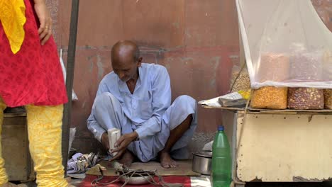 Elderly-Man-Preparing-and-Selling-a-Bag-of-Nuts