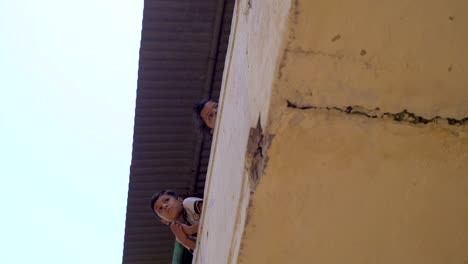 Two-Indian-Boys-Leaning-Over-a-Balcony