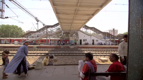 Indian-Man-Carries-Bags-Across-a-Train-Track