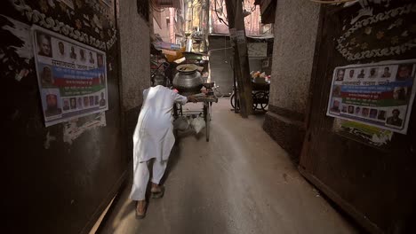 Indian-Man-Pushing-Cart-Down-Alleyway