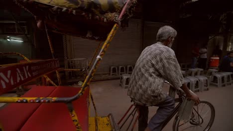 A-Man-Steers-a-Rickshaw-Down-a-Delhi-Street