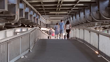 People-Walking-Under-Bridge-in-Berlin