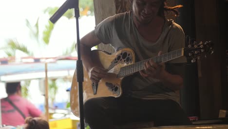 Man-Playing-Acoustic-Guitar