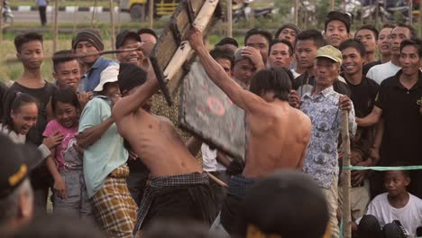 Indonesian-Men-Fighting-With-Sticks-and-Shields