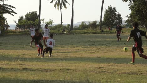 Men-Playing-Football-at-Sunset