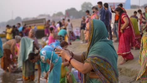 Woman-Pouring-Holy-Water-Into-the-Ganges