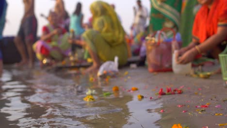 Low-Level-Shot-of-Bags-of-Flowers-by-the-Ganges