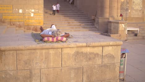 Elderly-Indian-Woman-Sunbathing-on-a-Wall