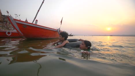 Boy-and-Girl-Swimming-in-the-Ganges-at-Sunset