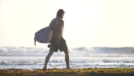 Surfer-Walking-Along-a-Beach