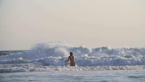 Surfer-Paddling-in-the-Waves