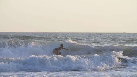 Tracking-Shot-of-a-Man-Surfing-in-the-Sea