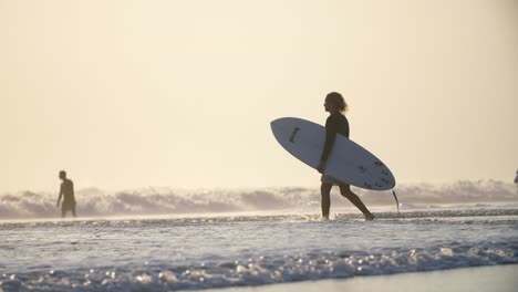 Man-Walking-into-the-Sea-with-a-Surfboard