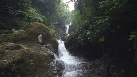 Man-Looking-at-a-Woodland-Waterfall