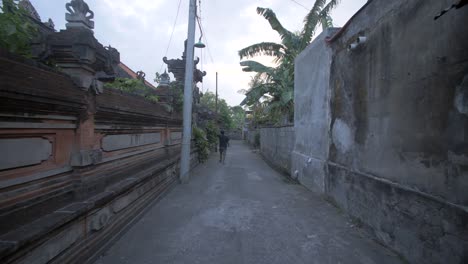 Man-Walking-Down-an-Indonesian-Street