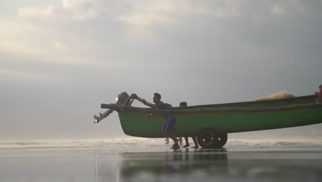 Boy-Wheeling-a-Fishing-Canoe-into-the-Sea
