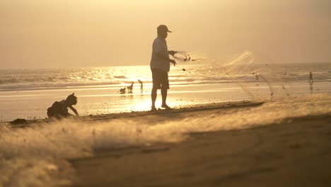Man-Folding-Fishing-Net-at-Sunset