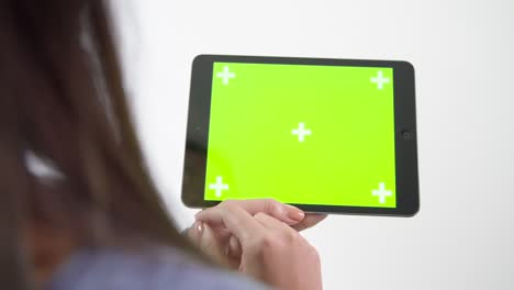 Young-Woman-Gesturing-on-Green-Screen-Tablet