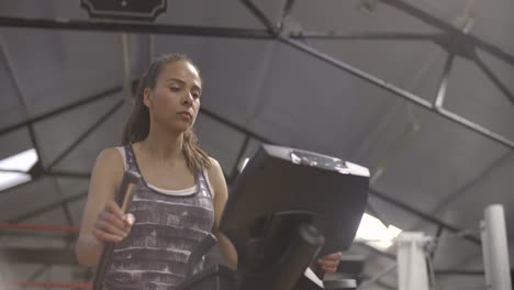 Woman-Using-Cross-Trainer-in-Gym