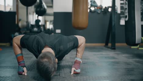 Man-Doing-Press-Ups-in-Boxing-Gym