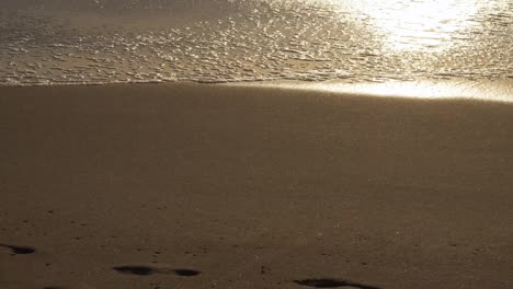 Wave-Washing-Away-Footprint-at-Sunset