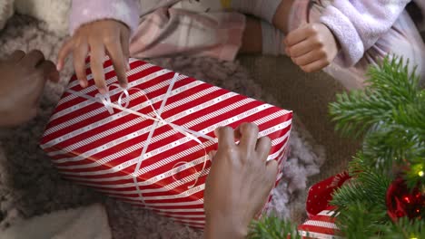 Top-View-of-Child-Unwrapping-Present