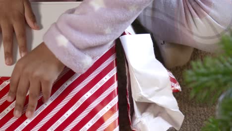 Close-Up-of-Child-Unwrapping-Present