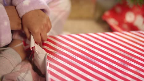 Child-Unwrapping-Present-Close-Up
