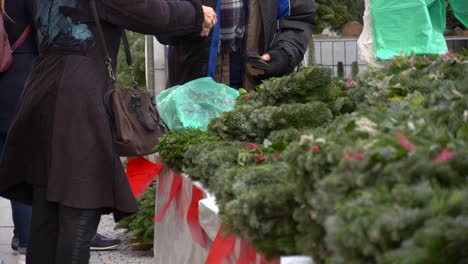 Woman-Buying-Christmas-Wreath