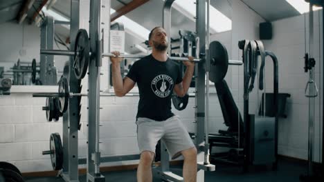 Man-Squatting-with-Weights-in-Gym