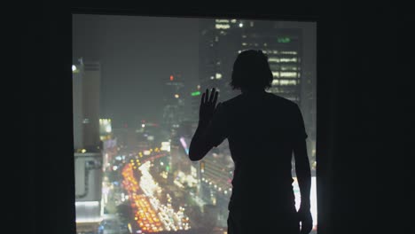 Silhouetted-Man-Looking-Out-of-Window