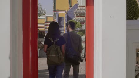 Couple-Walking-Through-Red-Doorway