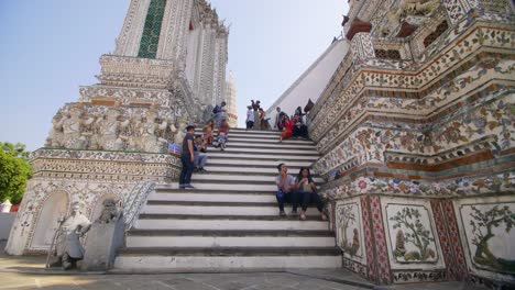 Tourists-Sitting-on-Steps-of-Temple