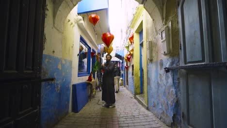 Shopkeeper-Hanging-Lanterns-in-Morocco