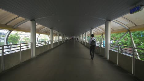 Man-Walking-Down-Walkway