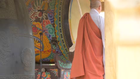 Buddhist-Monk-Striking-a-Bell