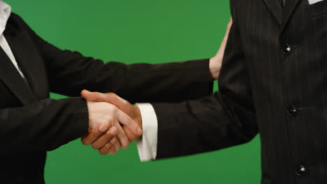 CU-Two-people-in-suits-shake-hands-on-green-screen