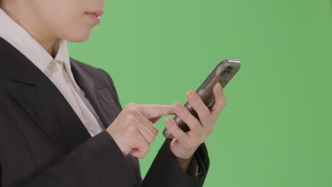CU-Businesswoman-sending-email-on-phone-with-green-screen