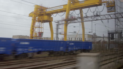 Looking-out-from-train-passing-gantry-crane